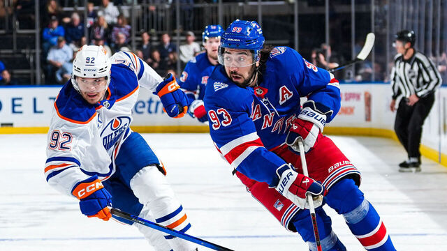 NEW YORK, NEW YORK - OCTOBER 14: Mika Zibanejad #93 of the New York Rangers skates with the puck against Vasily Podkolzin #92 of the Edmonton Oilers at Madison Square Garden on October 14, 2025 in New York City.
