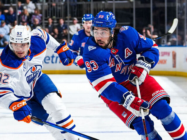 NEW YORK, NEW YORK - OCTOBER 14: Mika Zibanejad #93 of the New York Rangers skates with the puck against Vasily Podkolzin #92 of the Edmonton Oilers at Madison Square Garden on October 14, 2025 in New York City.