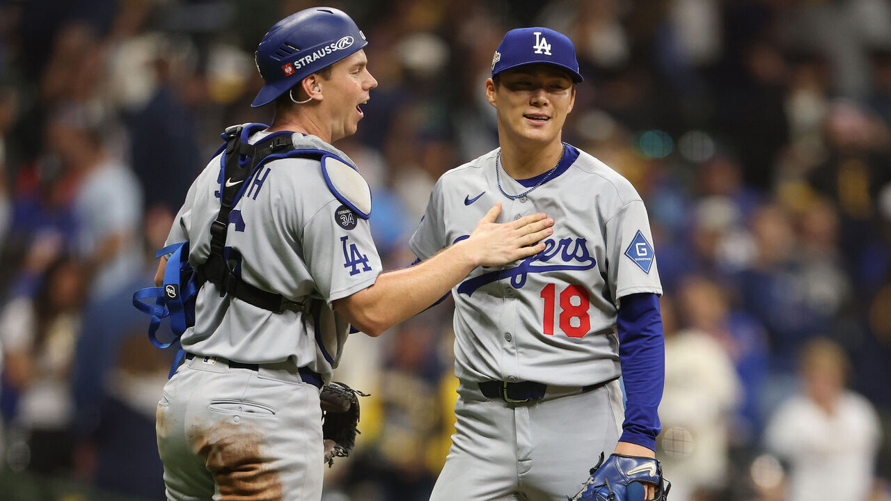 MILWAUKEE, WISCONSIN - OCTOBER 14: Will Smith #16 and Yoshinobu Yamamoto #18 of the Los Angeles Dodgers celebrate after beating the Milwaukee Brewers 5-1 in game two of the National League Championship Series at American Family Field on October 14, 2025 in Milwaukee, Wisconsin.
