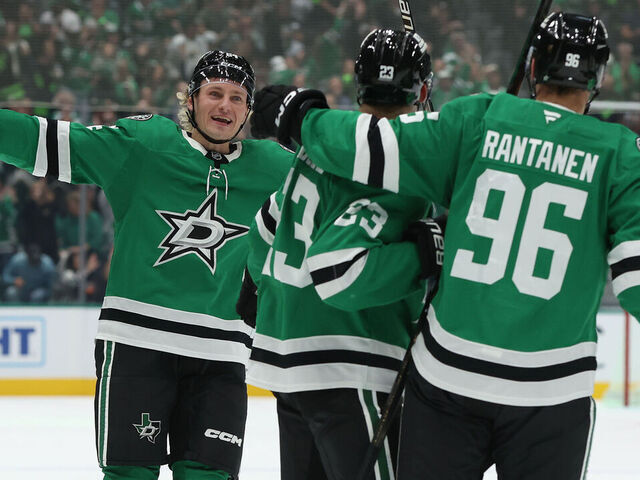 DALLAS, TEXAS - OCTOBER 14: Esa Lindell #23 of the Dallas Stars is congratulated by Roope Hintz #24 and Mikko Rantanen #96 after scoring a goal during the first period against the Minnesota Wild at American Airlines Center on October 14, 2025 in Dallas, Texas.