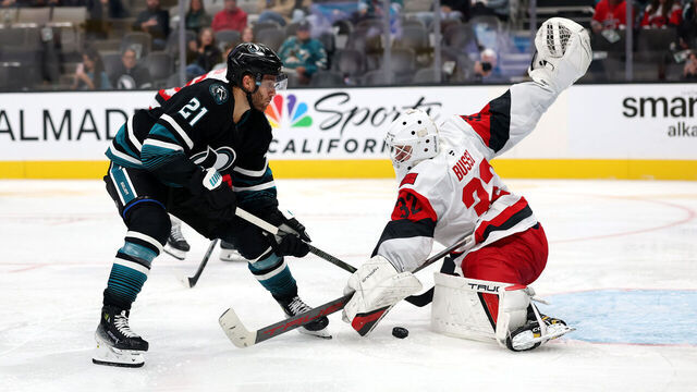 SAN JOSE, CALIFORNIA - OCTOBER 14: Brandon Bussi #32 of the Carolina Hurricanes makes a save on a shot taken by Alexander Wennberg #21 of the San Jose Sharks during the second period at SAP Center on October 14, 2025 in San Jose, California.