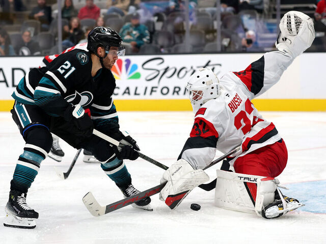 SAN JOSE, CALIFORNIA - OCTOBER 14: Brandon Bussi #32 of the Carolina Hurricanes makes a save on a shot taken by Alexander Wennberg #21 of the San Jose Sharks during the second period at SAP Center on October 14, 2025 in San Jose, California.