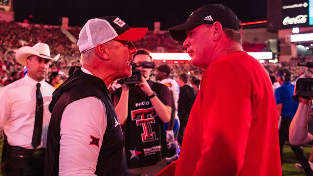 LUBBOCK, TEXAS - OCTOBER 11: Head coach Joey McGuire of the Texas Tech Red Raiders and Head Coach Lance Leipold of the Kansas Jayhawks talk at midfield after the game at Jones AT&T Stadium on October 11, 2025 in Lubbock, Texas.