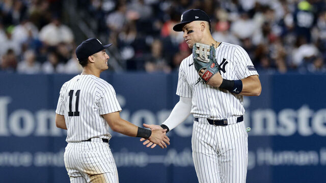 NEW YORK, NEW YORK - AUGUST 30: Anthony Volpe #11 and Aaron Judge #99 of the New York Yankees talk during the game against the St. Louis Cardinals at Yankee Stadium on August 30, 2024 in New York City. The Yankees defeated the Cardinals 6-3.
