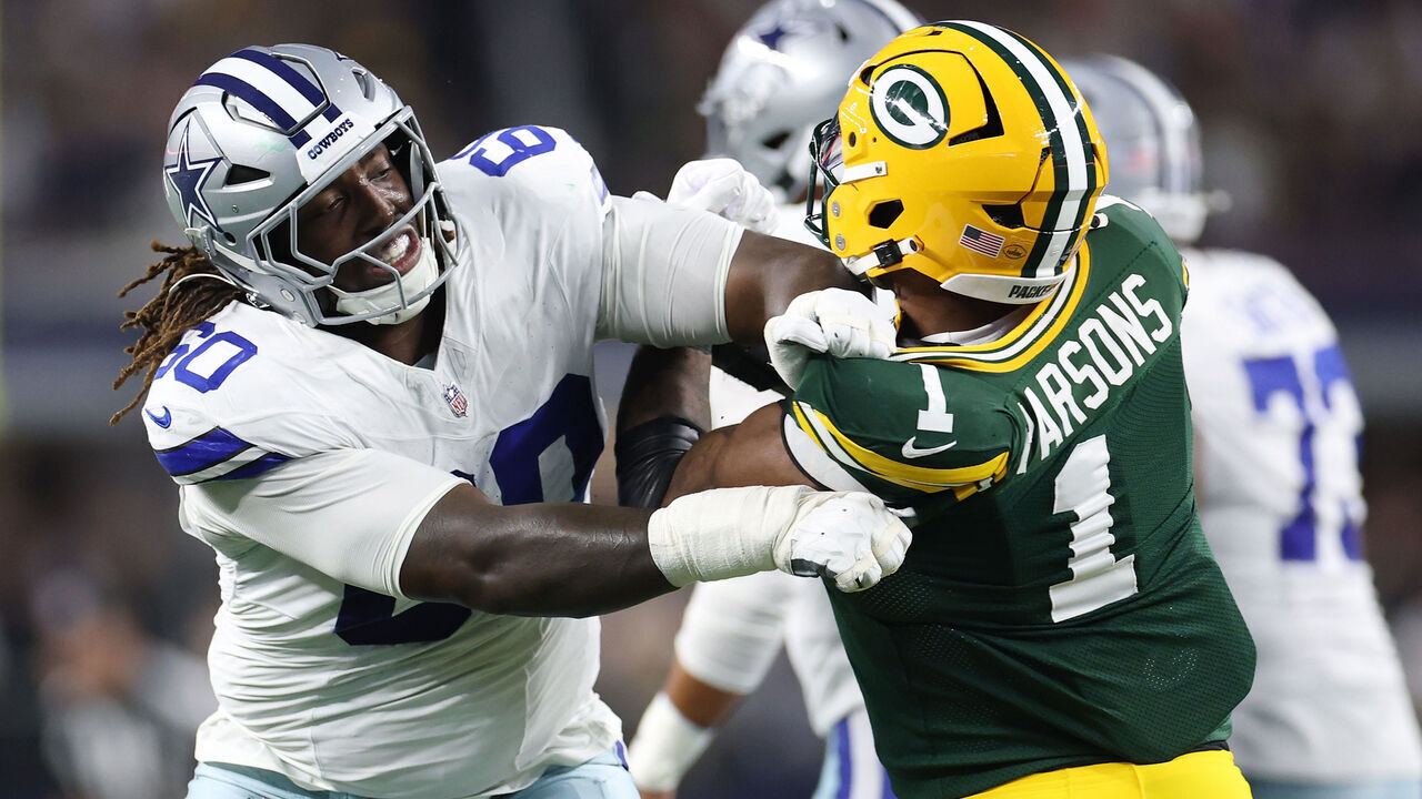 ARLINGTON, TEXAS - SEPTEMBER 28: Tyler Guyton #60 of the Dallas Cowboys works against Micah Parsons #1 of the Green Bay Packers during a game at AT&T Stadium on September 28, 2025 in Arlington, Texas.