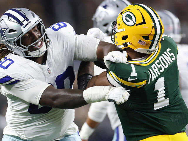ARLINGTON, TEXAS - SEPTEMBER 28: Tyler Guyton #60 of the Dallas Cowboys works against Micah Parsons #1 of the Green Bay Packers during a game at AT&T Stadium on September 28, 2025 in Arlington, Texas.