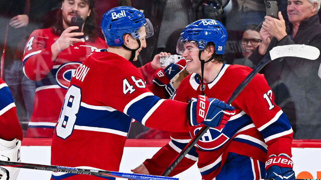 MONTREAL, CANADA - OCTOBER 14: Cole Caufield #13 of the Montréal Canadiens celebrates his overtime goal with teammate Lane Hutson #48 against the Seattle Kraken at the Bell Centre on October 14, 2025 in Montreal, Quebec, Canada. The Montréal Canadiens defeated the Seattle Kraken 5-4 in overtime.