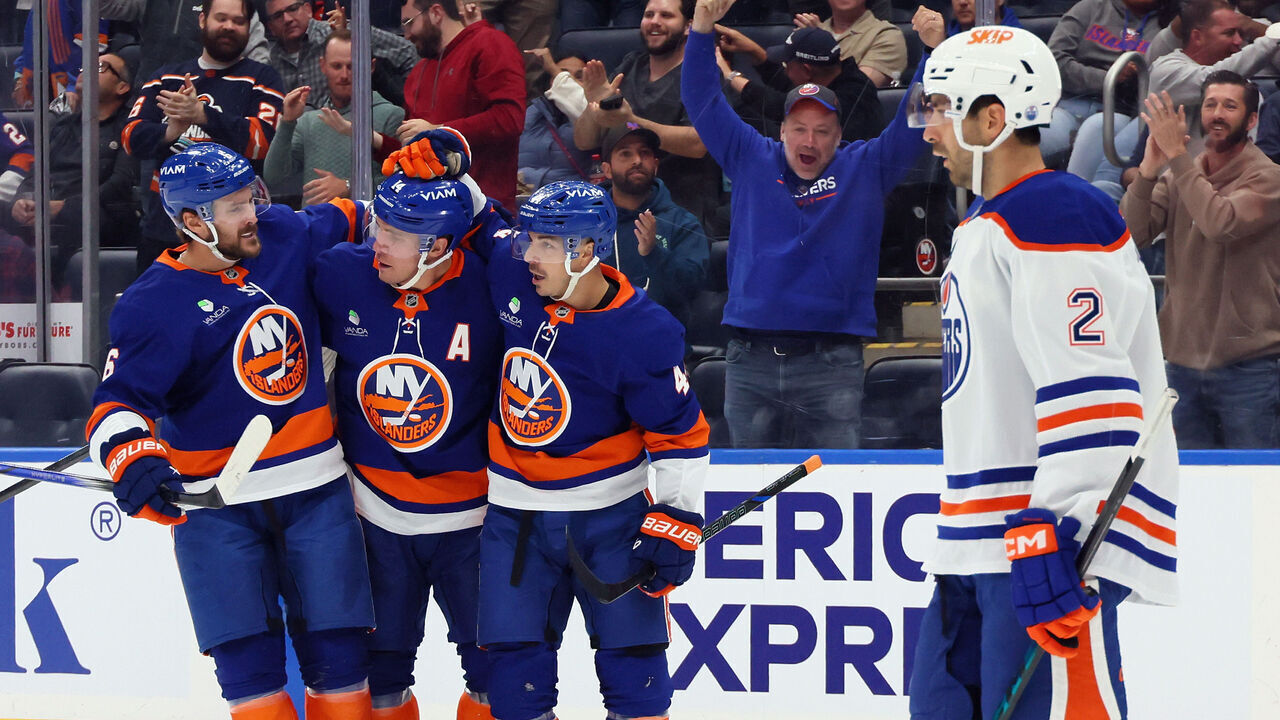 ELMONT, NEW YORK - OCTOBER 16: Bo Horvat #14 of the New York Islanders (c) celebrates his second period shorthanded goal against the Edmonton Oilers and is joined by Ryan Pulock #6 (l) and Jean-Gabriel Pageau #44 (r) at UBS Arena on October 16, 2025 in Elmont, New York.