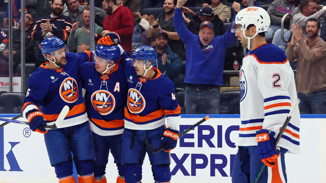 ELMONT, NEW YORK - OCTOBER 16: Bo Horvat #14 of the New York Islanders (c) celebrates his second period shorthanded goal against the Edmonton Oilers and is joined by Ryan Pulock #6 (l) and Jean-Gabriel Pageau #44 (r) at UBS Arena on October 16, 2025 in Elmont, New York.