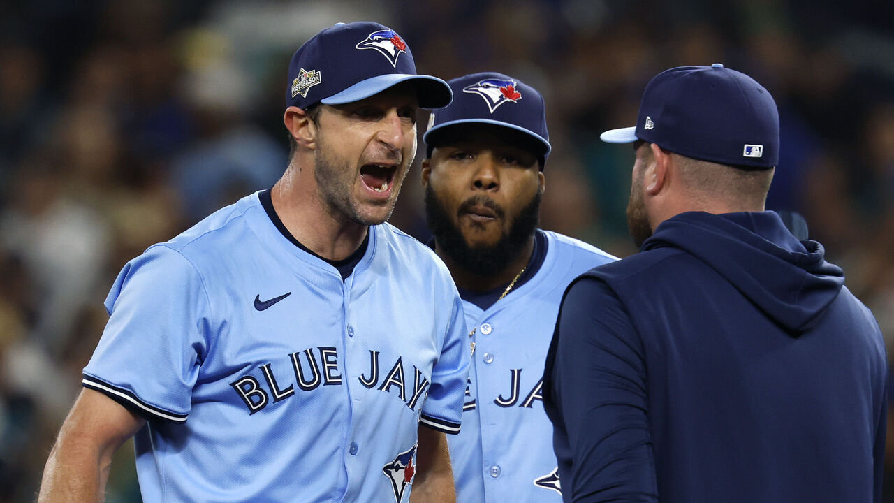 SEATTLE, WASHINGTON - OCTOBER 16: Manager John Schneider #14 of the Toronto Blue Jays walks to the mound to talk to Max Scherzer #31 during the fifth inning against the Seattle Mariners in game four of the American League Championship Series at T-Mobile Park on October 16, 2025 in Seattle, Washington.