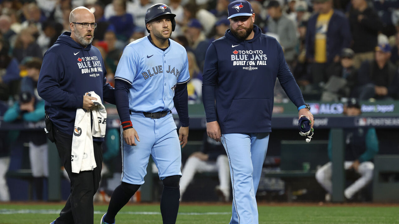 SEATTLE, WASHINGTON - OCTOBER 17: George Springer #4 of the Toronto Blue Jays (C) exits the game after being hit on the knee by a pitch during the seventh inning against the Seattle Mariners in game five of the American League Championship Series at T-Mobile Park on October 17, 2025 in Seattle, Washington.