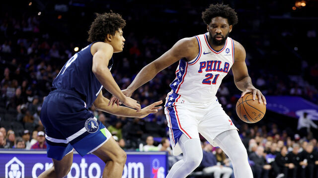 PHILADELPHIA, PENNSYLVANIA - OCTOBER 17: Joel Embiid #21 of the Philadelphia 76ers drives against Joan Beringer #19 of the Minnesota Timberwolves during the first half at Xfinity Mobile Arena on October 17, 2025 in Philadelphia, Pennsylvania.