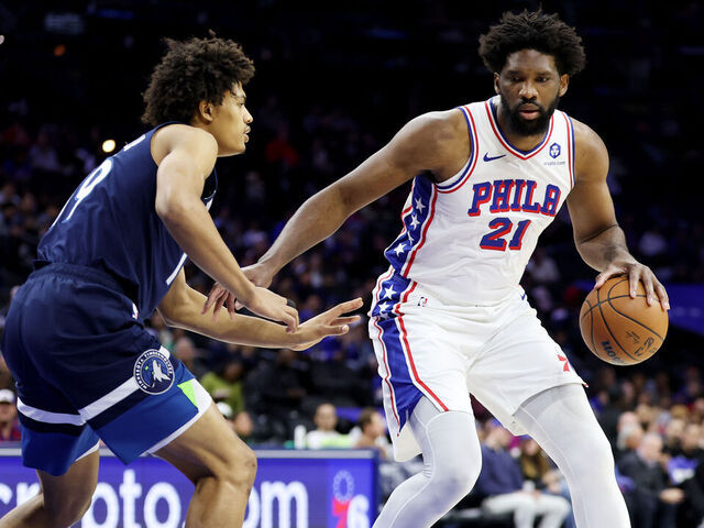 PHILADELPHIA, PENNSYLVANIA - OCTOBER 17: Joel Embiid #21 of the Philadelphia 76ers drives against Joan Beringer #19 of the Minnesota Timberwolves during the first half at Xfinity Mobile Arena on October 17, 2025 in Philadelphia, Pennsylvania.