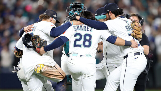 SEATTLE, WASHINGTON - OCTOBER 17: Eugenio Suárez #28 and Andrés Muñoz #75 of the Seattle Mariners celebrate with teammates after defeating the Toronto Blue Jays 6-2 in game five of the American League Championship Series at T-Mobile Park on October 17, 2025 in Seattle, Washington.