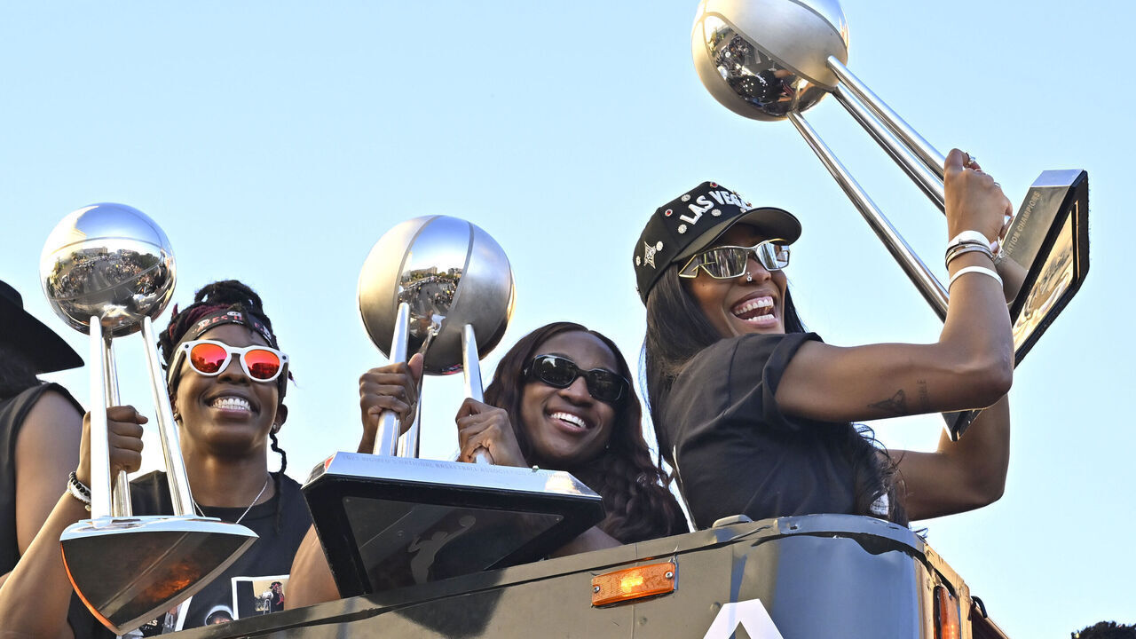 LAS VEGAS, NEVADA - OCTOBER 17: Chelsea Gray #12, Jackie Young #0 and A'ja Wilson #22 of the Las Vegas Aces smiles during the Las Vegas Aces' WNBA championship victory parade and rally on the Las Vegas Strip on October 17, 2025 in Las Vegas, Nevada. The Aces defeated the Phoenix Mercury on Friday in Game Four of the 2025 WNBA Playoffs finals to win the 2025 title.
