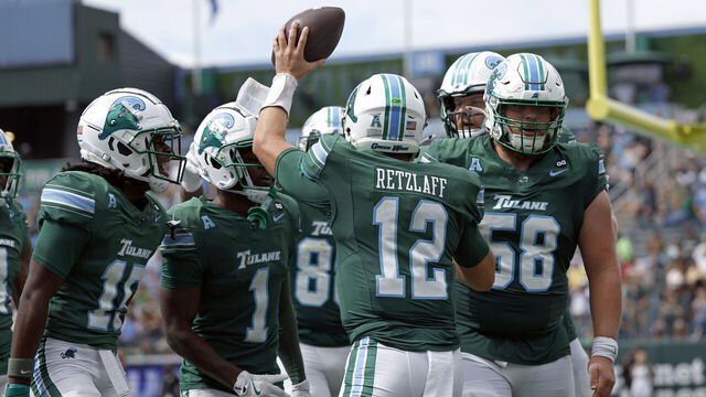 NEW ORLEANS, LOUISIANA - OCTOBER 18: Quarterback Jake Retzlaff #12 of the Tulane Green Wave holds up the ball after a touchdown during the second half of a game against the Army West Point Black Knights at Yulman Stadium on October 18, 2025 in New Orleans, Louisiana.