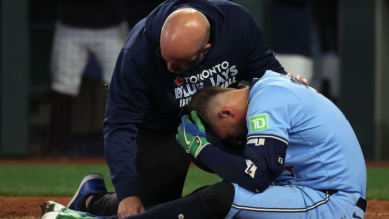 SEATTLE , WA - OCTOBER 17 - Seattle Mariners catcher Cal Raleigh (29) looks on as Toronto Blue Jays right fielder George Springer (4) gets hit by a pitch on his knee by Seattle Mariners pitcher Bryan Woo (22) as the Toronto Blue Jays play the Seattle Mariners in game five of their ALCS MLB Playoff series at T-Mobile Stadium in Seattle . October 17, 2025.