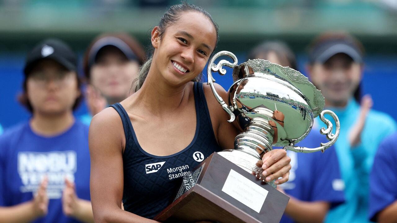 Canada's Leylah Fernandez poses with the winner's trophy after defeating Czech Republic's Tereza Valentova in their women's singles final match at the Japan Open tennis tournament in Osaka on October 19, 2025.