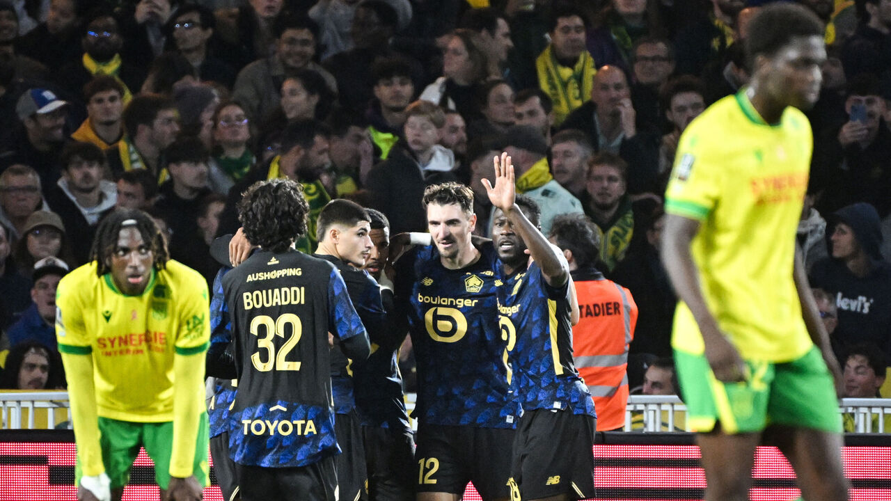 Lille's Moroccan forward #29 Hamza Igamane (unseen) celebrates with teammates after scoring his team second goal during the French L1 football match between FC Nantes and Lille LOSC at the Stade de la BeaujoireLouis Fonteneau in Nantes, western France, on October 19, 2025.