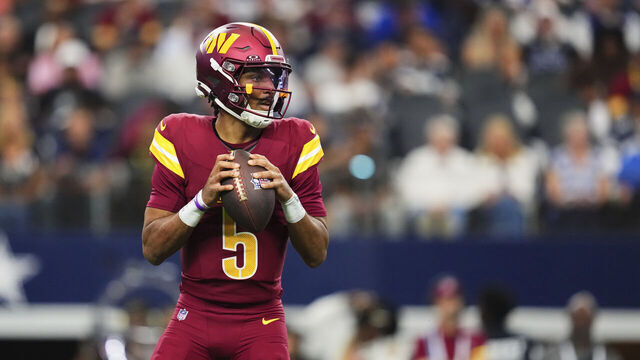 ARLINGTON, TX - OCTOBER 19: Jayden Daniels #5 of the Washington Commanders drops back to pass against the Dallas Cowboys during the first half of the NFL football game at AT&T Field on October 19, 2025 in Arlington, Texas.