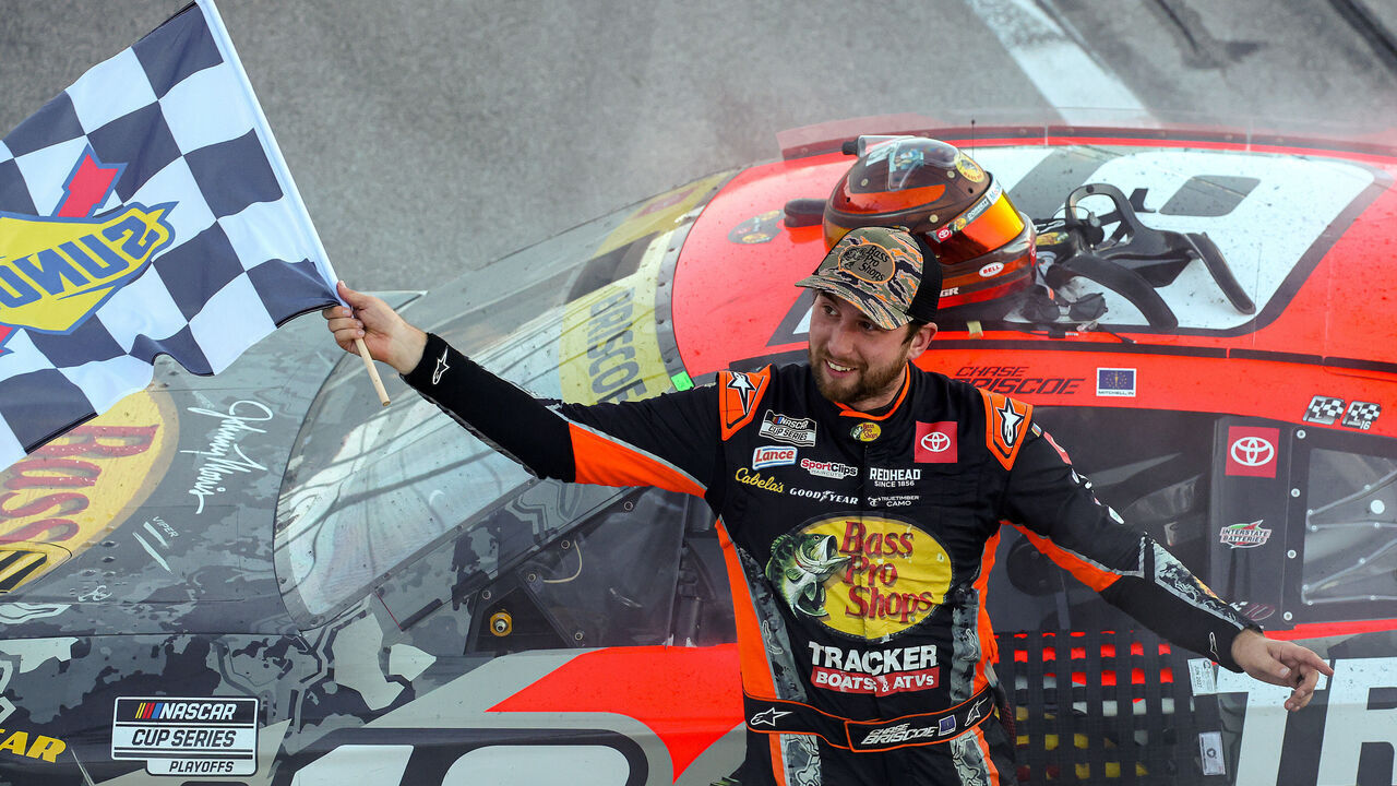 TALLADEGA, ALABAMA - OCTOBER 19: Chase Briscoe, driver of the #19 Bass Pro Shops Toyota, celebrates with the checkered flag after winning the NASCAR Cup Series YellaWood 500 at Talladega Superspeedway on October 19, 2025 in Talladega, Alabama.