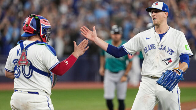 TORONTO, ON - OCTOBER 19: Alejandro Kirk #30 and Jeff Hoffman #23 of the Toronto Blue Jays celebrate after winning Game Six of the American League Championship Series presented by loanDepot between the Seattle Mariners and the Toronto Blue Jays at Rogers Centre on Sunday, October 19, 2025 in Toronto, Ontario, Canada.
