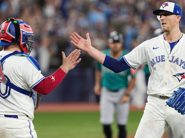 TORONTO, ON - OCTOBER 19: Alejandro Kirk #30 and Jeff Hoffman #23 of the Toronto Blue Jays celebrate after winning Game Six of the American League Championship Series presented by loanDepot between the Seattle Mariners and the Toronto Blue Jays at Rogers Centre on Sunday, October 19, 2025 in Toronto, Ontario, Canada.