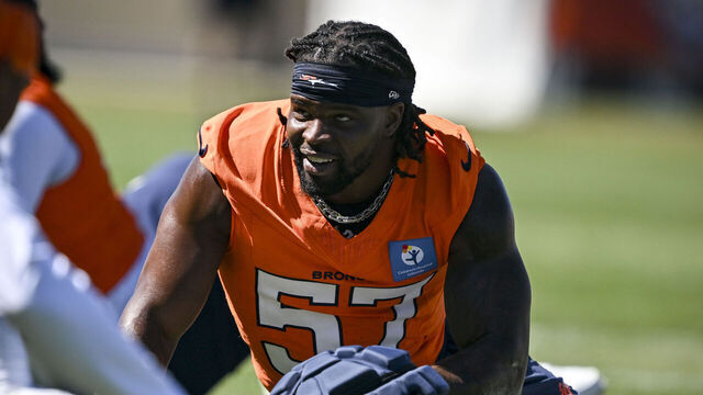 CENTENNIAL , CO - AUGUST 12: Dre Greenlaw (57) of the Denver Broncos stretches during training camp at Broncos Park in Centennial, Colorado on Tuesday, August 12, 2025.