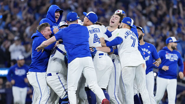 TORONTO, ONTARIO - OCTOBER 20: Toronto Blue Jays players celebrate on the field after defeating the Seattle Mariners in game seven of the American League Championship Series at the Rogers Centre on October 20, 2025 in Toronto, Ontario.