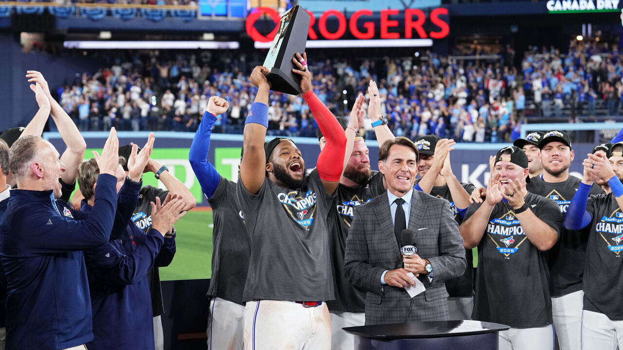 TORONTO, ONTARIO - OCTOBER 20: Vladimir Guerrero Jr. #27 of the Toronto Blue Jays lifts the William Harridge Trophy after winning game seven of the American League Championship Series against the Seattle Mariners at the Rogers Centre on October 20, 2025 in Toronto, Ontario.