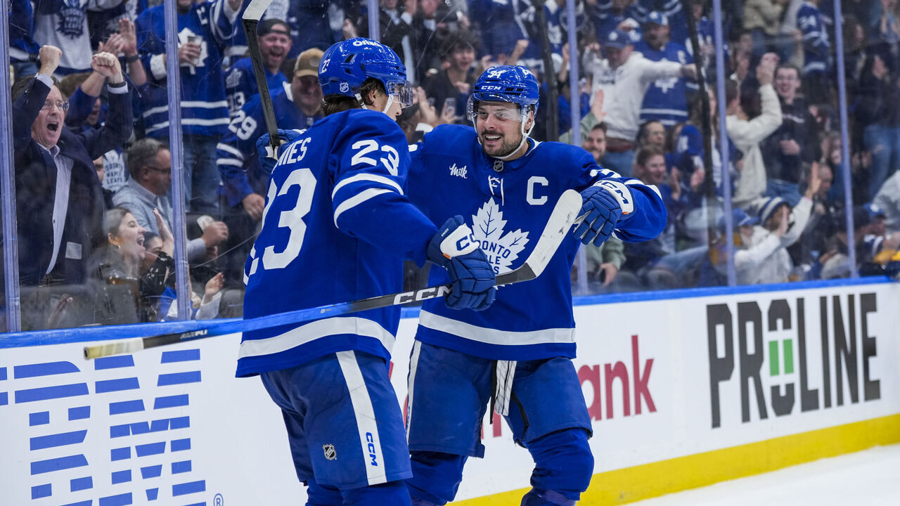 TORONTO, CANADA - OCTOBER 14: Auston Matthews #34 celebrates scoring a goal with Matthew Knies #23 of the Toronto Maple Leafs against the Nashville Predators during the third period at the Scotiabank Arena on October 14, 2025 in Toronto, ON, Canada.