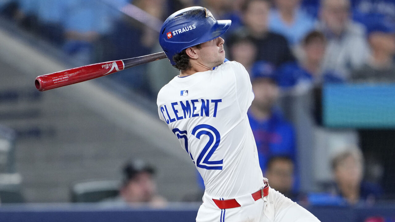 TORONTO, ONTARIO - OCTOBER 19: Ernie Clement #22 of the Toronto Blue Jays hits a triple during the third inning against the Seattle Mariners in game six of the American League Championship Series at Rogers Centre on October 19, 2025 in Toronto, Ontario.