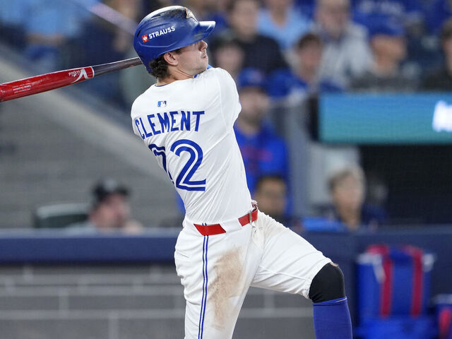 TORONTO, ONTARIO - OCTOBER 19: Ernie Clement #22 of the Toronto Blue Jays hits a triple during the third inning against the Seattle Mariners in game six of the American League Championship Series at Rogers Centre on October 19, 2025 in Toronto, Ontario.