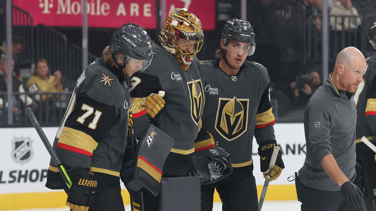 LAS VEGAS, NEVADA - OCTOBER 20: Adin Hill #33 of the Vegas Golden Knights is helped off the ice after suffering an injury during the first period against the Carolina Hurricanes at T-Mobile Arena on October 20, 2025 in Las Vegas, Nevada.