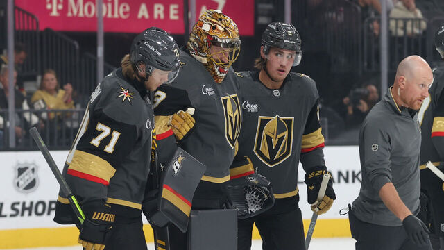 LAS VEGAS, NEVADA - OCTOBER 20: Adin Hill #33 of the Vegas Golden Knights is helped off the ice after suffering an injury during the first period against the Carolina Hurricanes at T-Mobile Arena on October 20, 2025 in Las Vegas, Nevada.