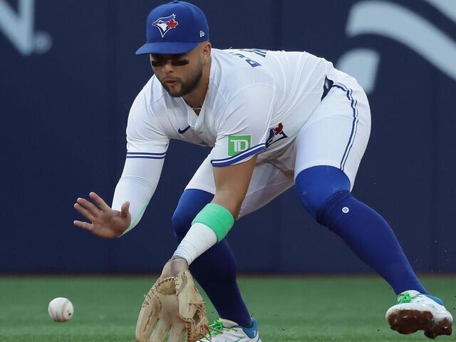 TORONTO, ON - JULY 22 - Toronto Blue Jays shortstop Bo Bichette (11) fields a grounder from New York Yankees shortstop Anthony Volpe (11) in the second inning as the Toronto Blue Jays play the New York Yankees at Rogers Centre in Toronto. July 22, 2025.