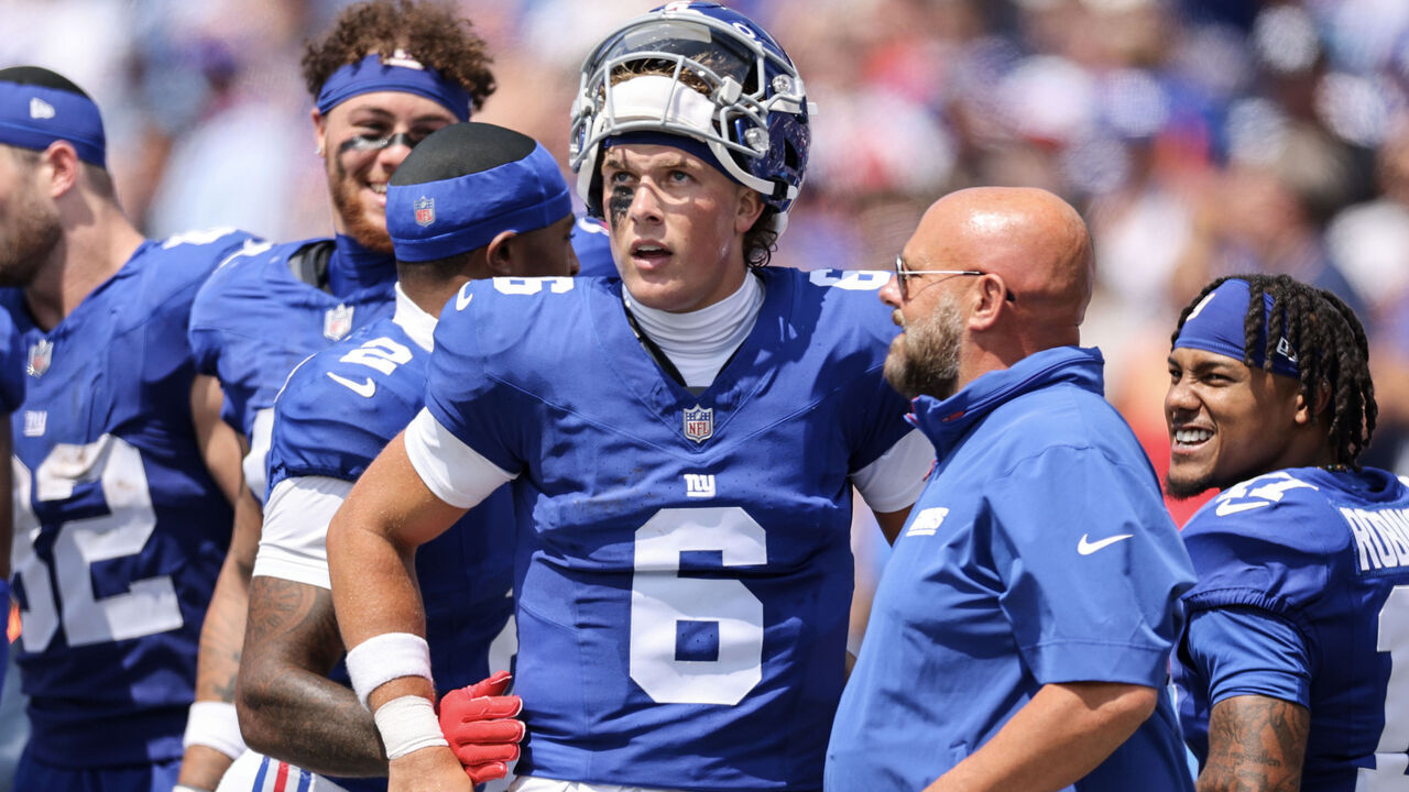 ORCHARD PARK, NEW YORK - AUGUST 09: Jaxson Dart #6 of the New York Giants and head coach Brian Daboll speak during the second quarter of an NFL Preseason 2025 game between New York Giants and Buffalo Bills at Highmark Stadium on August 09, 2025 in Orchard Park, New York.