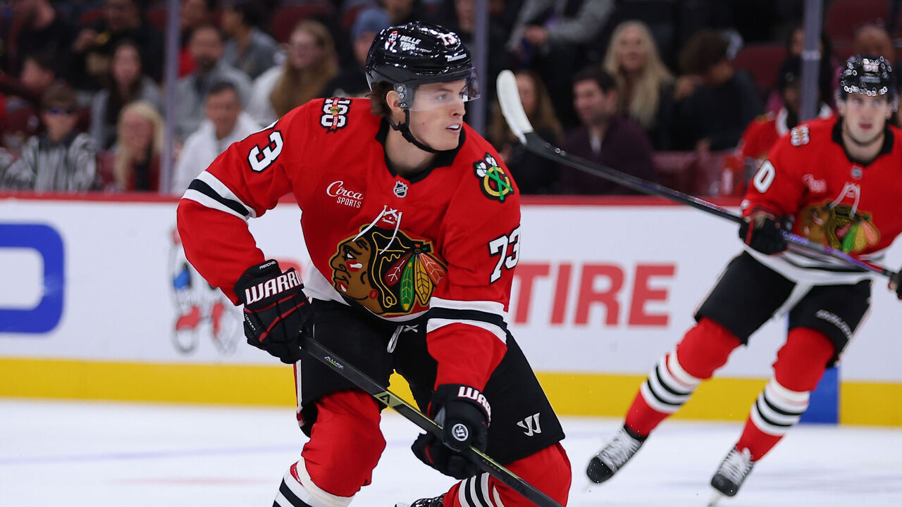 CHICAGO, IL - OCTOBER 17: Lukas Reichel #73 of the Chicago Blackhawks brings the puck up ice during the first period against the Vancouver Canucks on October 17, 2025 at the United Center in Chicago, Illinois.