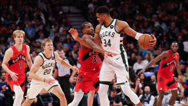 TORONTO, CANADA - OCTOBER 24: Ochai Agbaji #30 of the Toronto Raptors defends against Giannis Antetokounmpo #34 of the Milwaukee Bucks during the second half at Scotiabank Arena on October 24, 2025 in Toronto, Ontario, Canada.