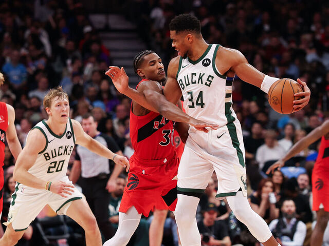 TORONTO, CANADA - OCTOBER 24: Ochai Agbaji #30 of the Toronto Raptors defends against Giannis Antetokounmpo #34 of the Milwaukee Bucks during the second half at Scotiabank Arena on October 24, 2025 in Toronto, Ontario, Canada.