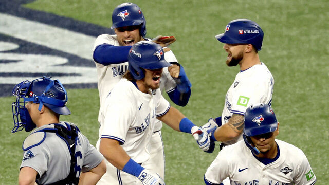 Toronto, Ontario, Canada. October, 24, 2025: Toronto Blue Jays third baseman Addison Barger (47), center, celebrates with teammates after his grand slam in the sixth inning during Game one of the World Series between the Los Angeles Angeles and the Toronto Blue Jays at Roger Centre on Friday, October 24, 2025 in Toronto, Ontario, Canada.(Gina Ferazzi / Los Angeles Times via Getty Images)