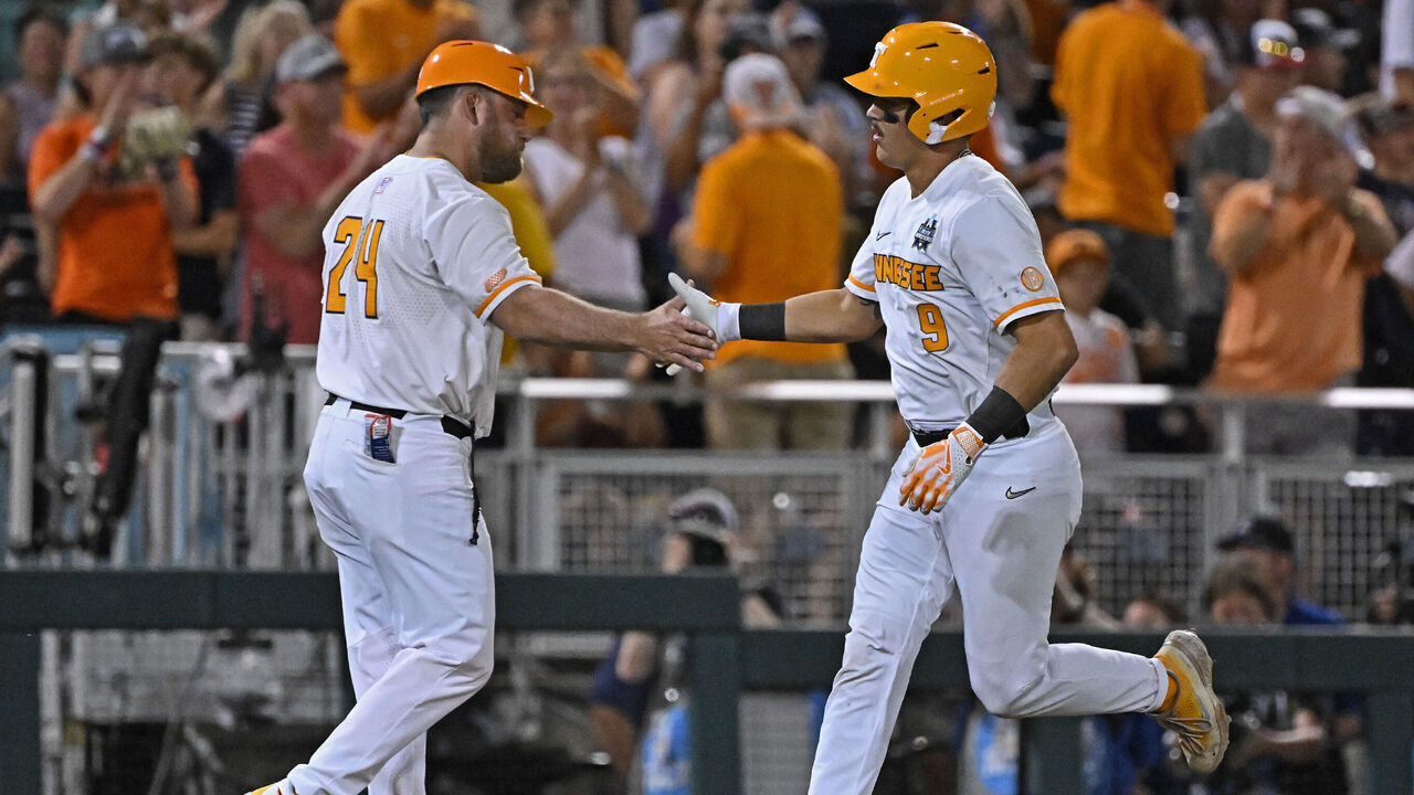 OMAHA, NE - JUNE 22: Hunter Ensley #9 of the Tennessee Volunteers celebrates with third base coach Josh Elander #24 after hitting a solo home run in the seventh inning against the Texas A&M Aggies during the NCAA Division I Baseball Championship on June 22, 2024 at Charles Schwab Field in Omaha, Nebraska.
