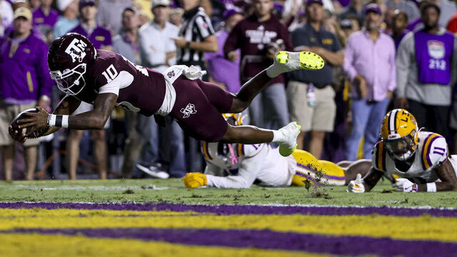 BATON ROUGE, LOUISIANA - OCTOBER 25: Marcel Reed #10 of the Texas A&M Aggies dives in for a touchdown against the LSU Tigers during the first half of a game at Tiger Stadium on October 25, 2025 in Baton Rouge, Louisiana.