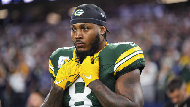 ARLINGTON, TEXAS - SEPTEMBER 28: Josh Jacobs #8 of the Green Bay Packers looks on from the sideline during the national anthem prior to an NFL football game against the Dallas Cowboys at AT&T Field on September 28, 2025 in Arlington, Texas.