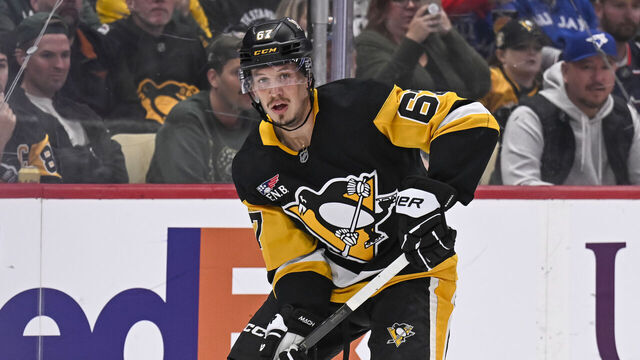 PITTSBURGH, PA - OCTOBER 25: Pittsburgh Penguins right wing Rickard Rakell (67) handles the puck during the second period in the NHL game between the Pittsburgh Penguins and the Columbus Blue Jackets on October 25, 2025, at PPG Paints Arena in Pittsburgh, PA.