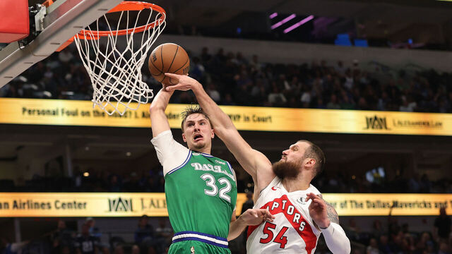 DALLAS, TEXAS - OCTOBER 26: Cooper Flagg #32 of the Dallas Mavericks dunks over Sandro Mamukelashvili #54 of the Toronto Raptors during the second half at American Airlines Center on October 26, 2025 in Dallas, Texas.