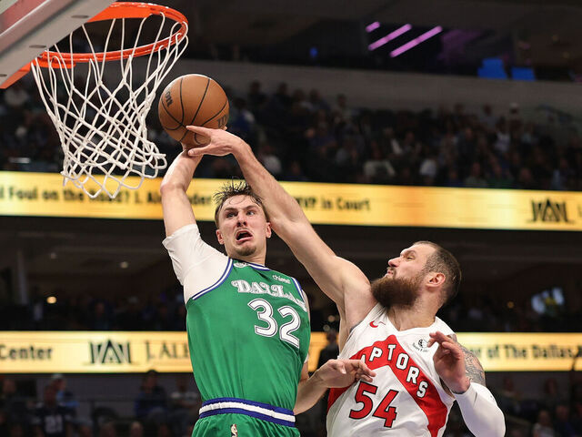 DALLAS, TEXAS - OCTOBER 26: Cooper Flagg #32 of the Dallas Mavericks dunks over Sandro Mamukelashvili #54 of the Toronto Raptors during the second half at American Airlines Center on October 26, 2025 in Dallas, Texas.