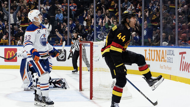VANCOUVER, CANADA - OCTOBER 26: Ryan Nugent-Hopkins looks on as Kiefer Sherwood #44 of the Vancouver Canucks celebrates after scoring on Calvin Pickard #30 in overtime during their NHL game at Rogers Arena on October 26, 2025 in Vancouver, British Columbia, Canada.