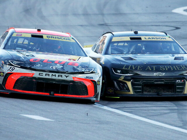 LAS VEGAS, NV - OCTOBER 12: Chase Briscoe (#19 Joe Gibbs Racing Bass Pro Shops Toyota) and Kyle Larson (#5 Hendrick Motorsports HendrickCars.com Chevrolet) go door to door battling for position during the NASCAR Cup Series South Point 400 race on October 12, 2025, at Las Vegas Motor Speedway in Las Vegas, NV.