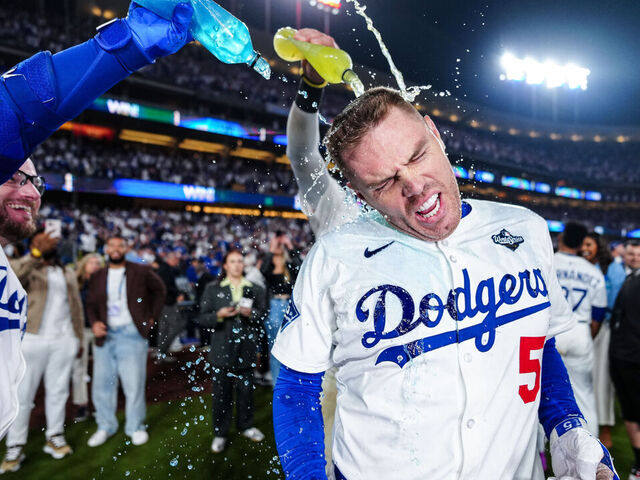 LOS ANGELES, CA - OCTOBER 27: Max Muncy #13 and Freddie Freeman #5 of the Los Angeles Dodgers celebrate after Freeman's walk-off home run in the 18th inning of Game Three of the 2025 World Series presented by Capital One between the Toronto Blue Jays and the Los Angeles Dodgers at Dodger Stadium on Monday, October 27, 2025 in Los Angeles, California.